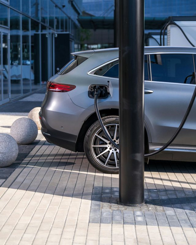 Electric vehicle plugged in to charge
