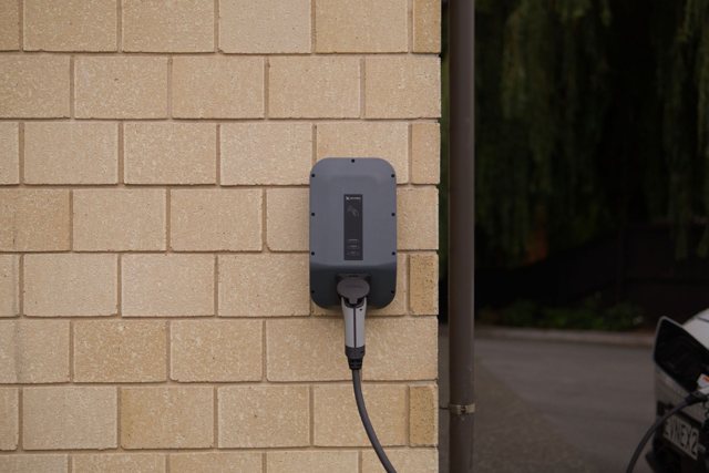 Level 2 EV charger mounted on a garage wall