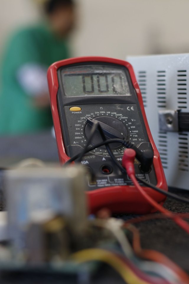 Digital multimeter used to diagnose an electrical fault