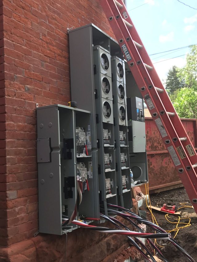 Multi-unit meter bank on a brick apartment building